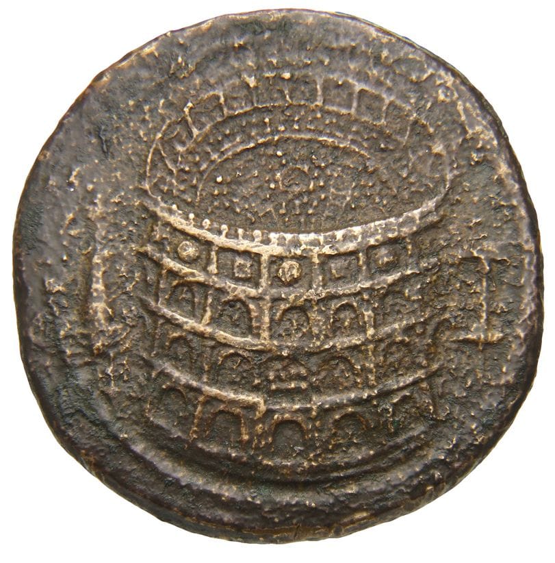 A bronze Roman coin showing the Colosseum from above, its stands dotted with people