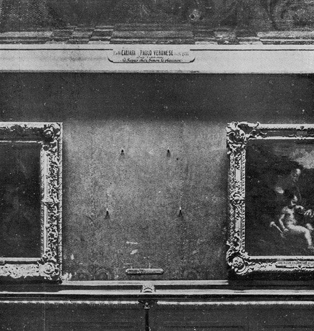 The bare wall in the Salon Carré where the Mona Lisa hung, with the four iron hooks that held her